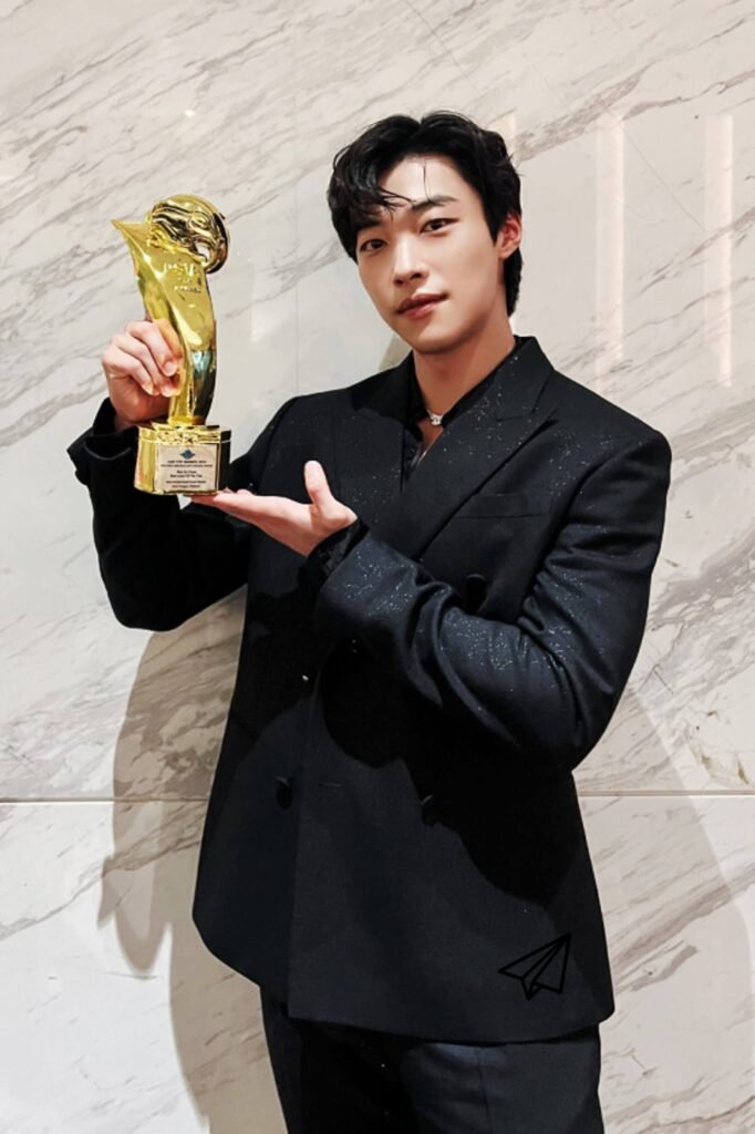 Woo Do-hwan standing with the trophy