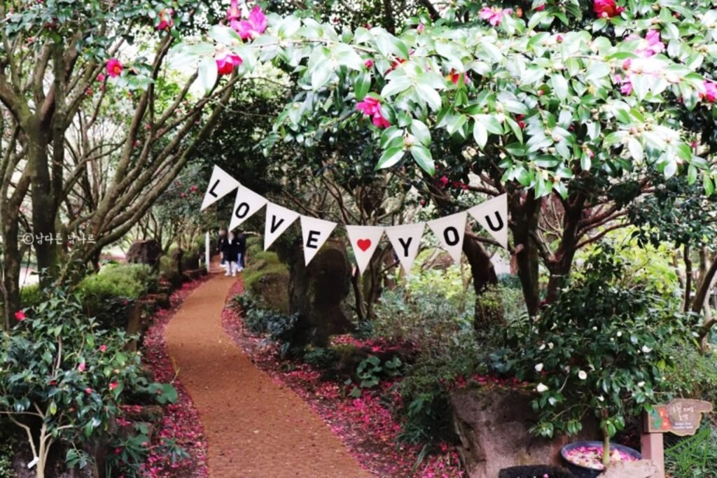 A narrow path runs through a tree-lined garden.