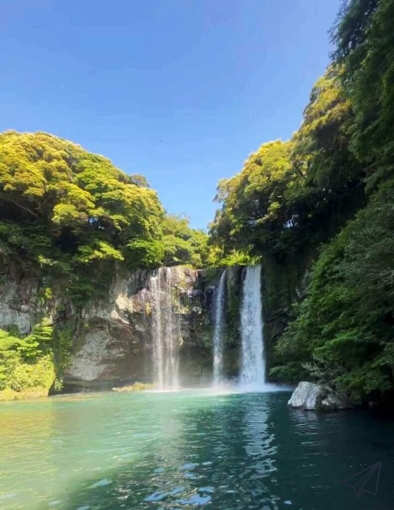 Water is falling from above in several streams at Cheonjiyeon Falls.