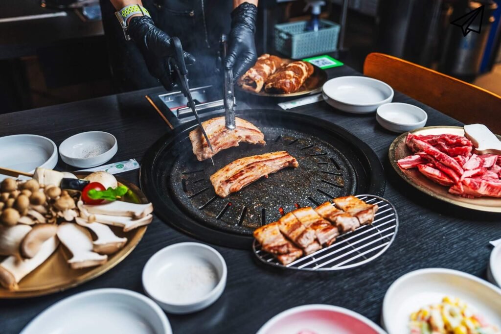 Grilling and cutting pork belly on a grill