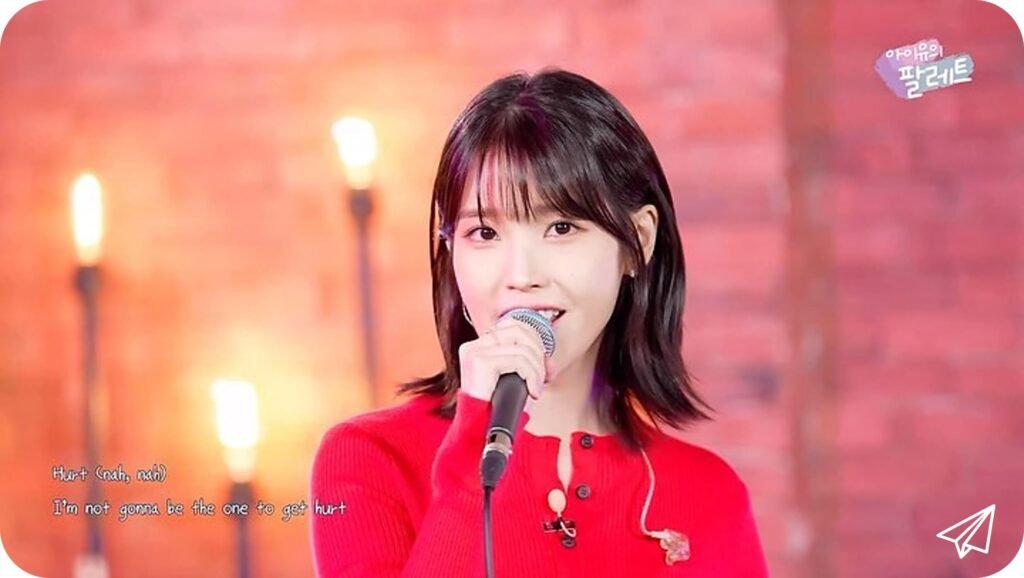 IU singing in a red dress