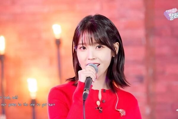 IU singing in a red dress