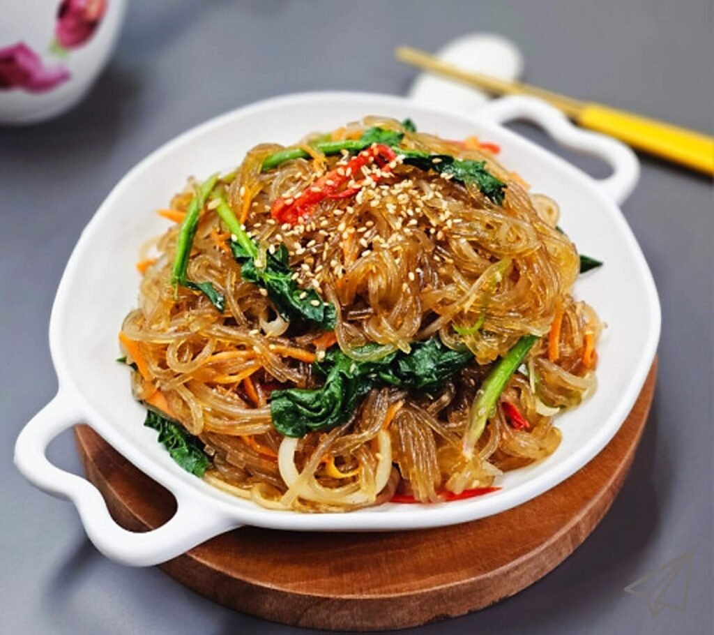 Japchae with spinach and sesame seeds is well cooked.