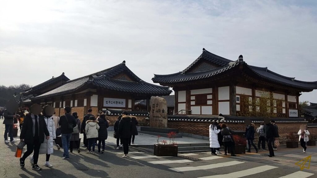 People are busily passing by on the streets of Hanok Village.