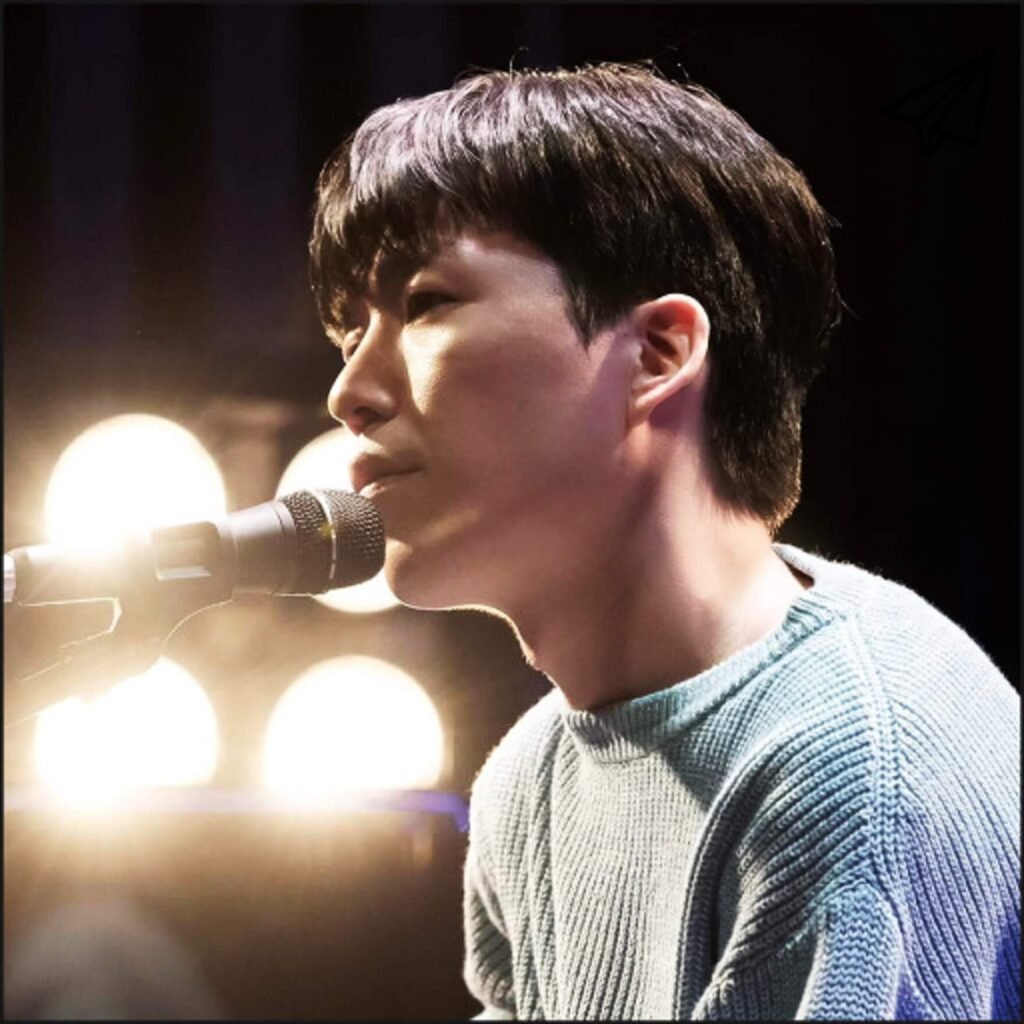Kwak Jin-eon singing in front of a microphone