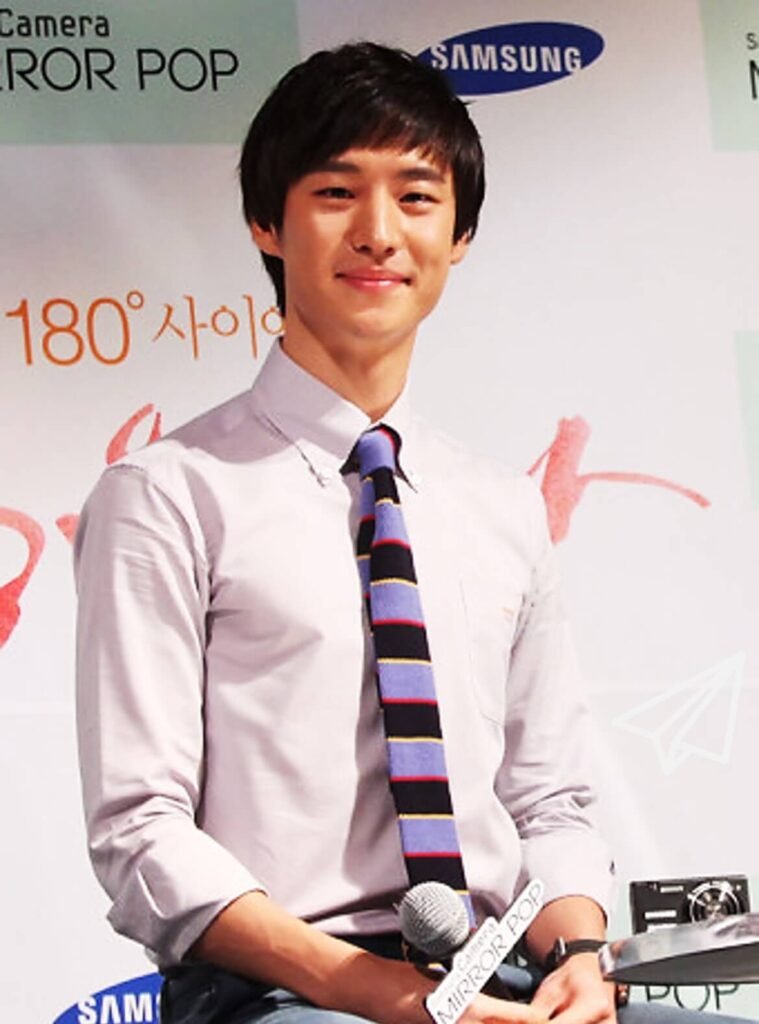Actor Lee Je-hoon wearing a tie and white shirt during his college days