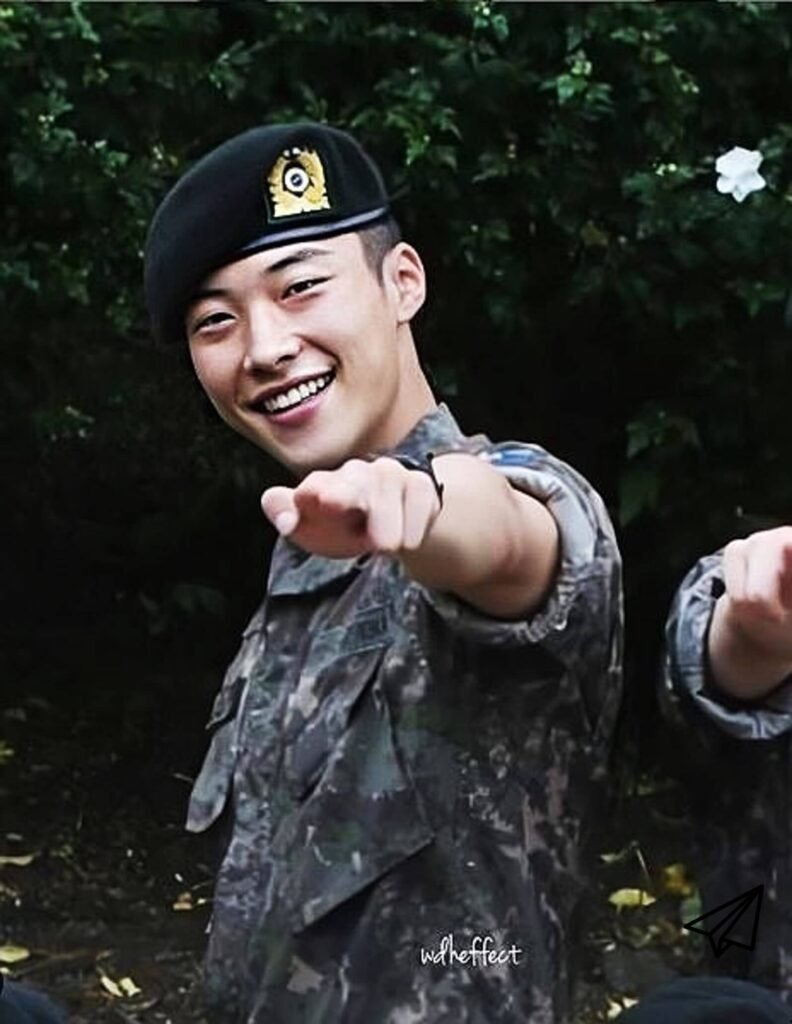 A picture of him in his military uniform smiling brightly while being discharged