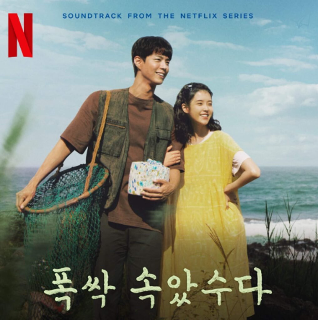 IU and Park Bo Kyung smiling while holding fishing nets