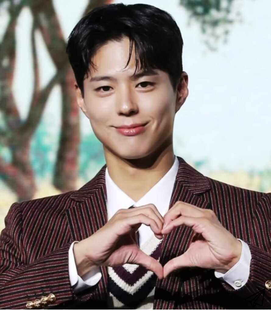 Park Bo-gum smiling while making a heart with both hands