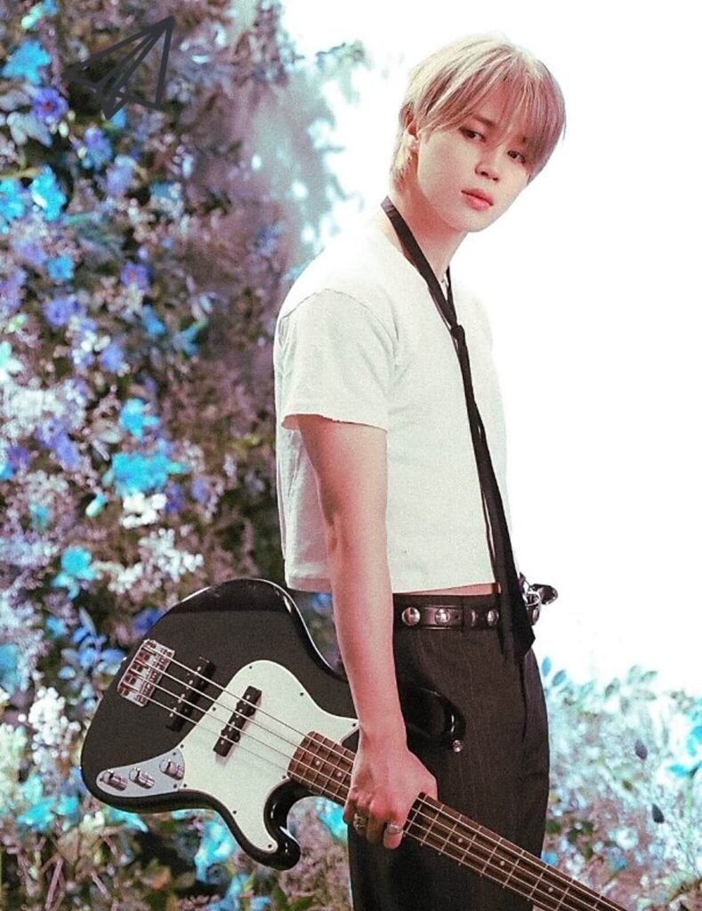 Jimin holding a guitar